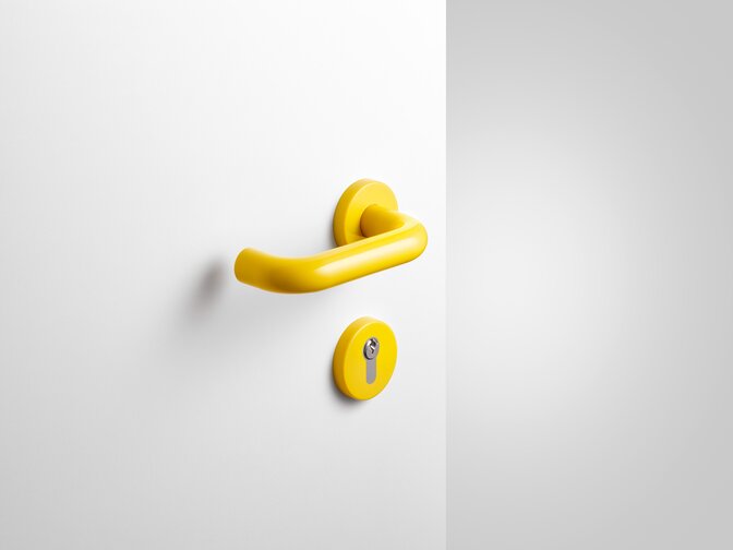 HEWI lever handle mustard yellow Lever handle with key rosette in the colour mustard yellow made of polyamide