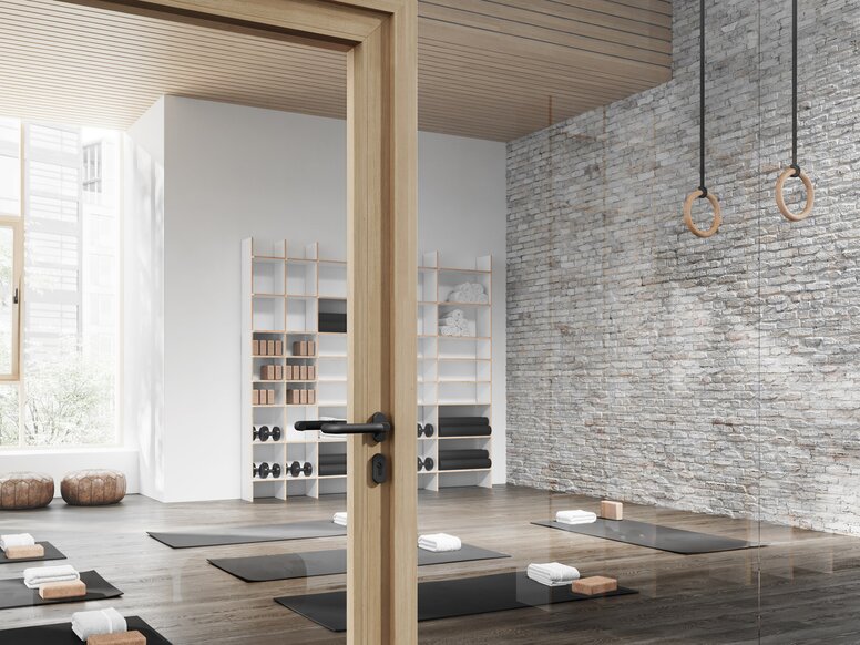 Glass door with wooden frame to a yoga room