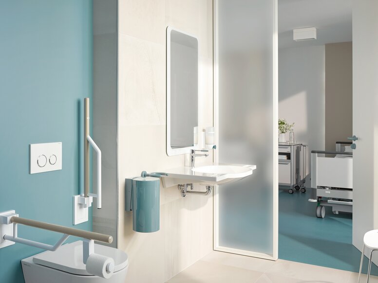 HEWI Series 800K Barrier-free patient bathroom equipped with white and blue sanitary accessories