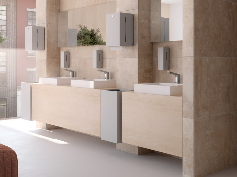 HEWI SENSORIC dispensers and fittings Three public washrooms equipped with touch-free taps, soap and paper towel dispensers